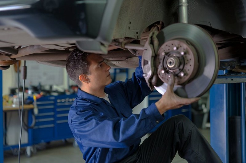 Mechanic-under-car-doing-brake-services-at-Schoonover