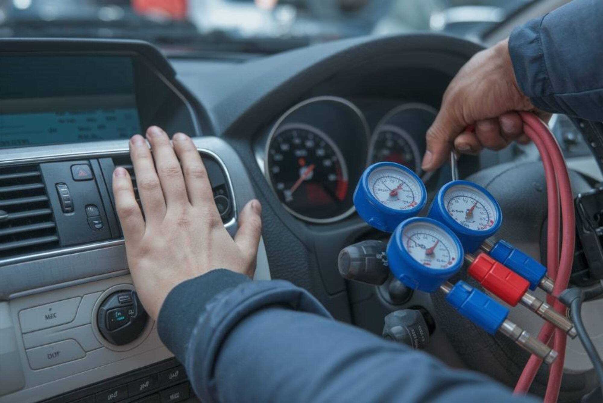Air Conditioning Services tech in car