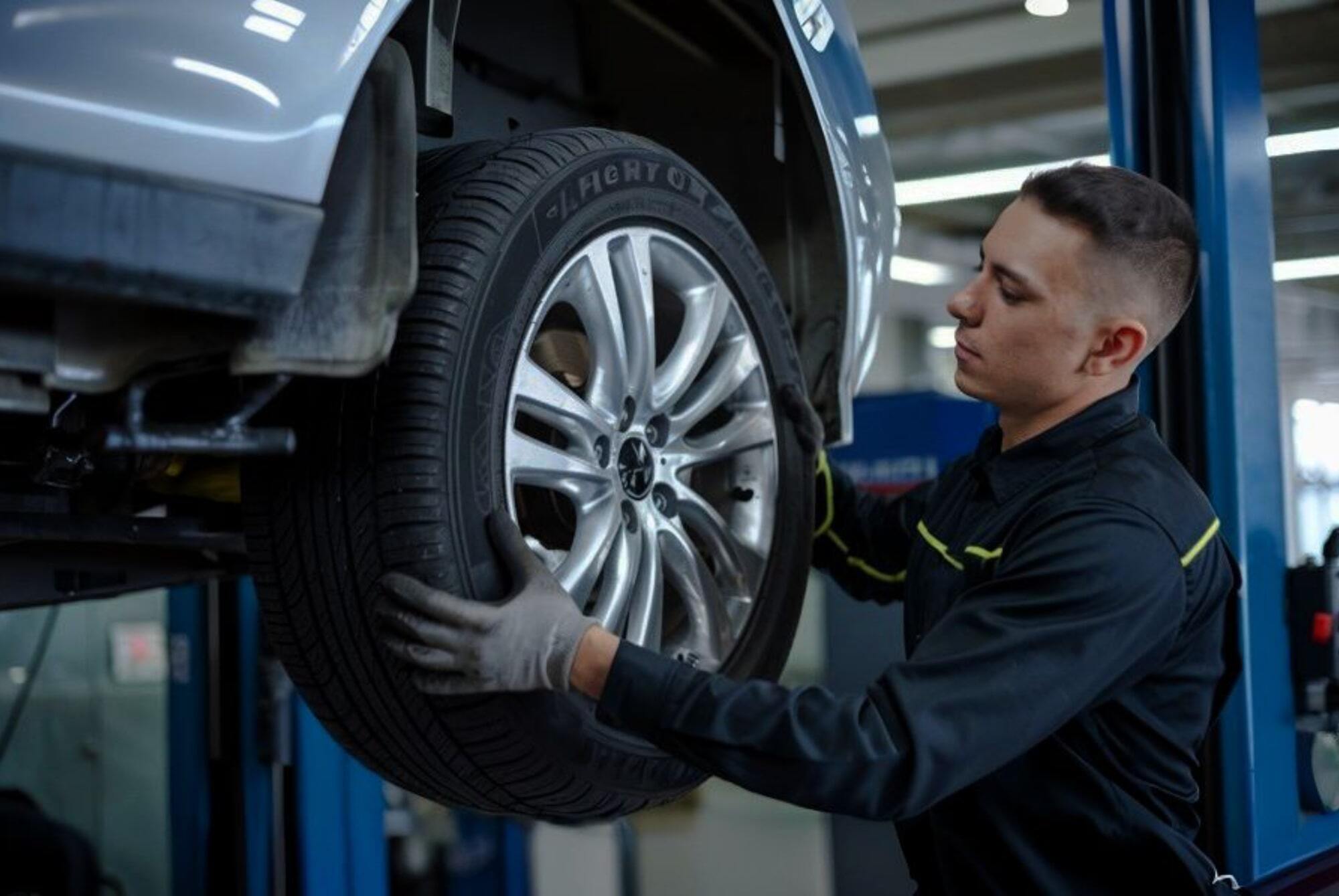 Tire Change Service tech mounting tire Tire Change Service tech mounting tire