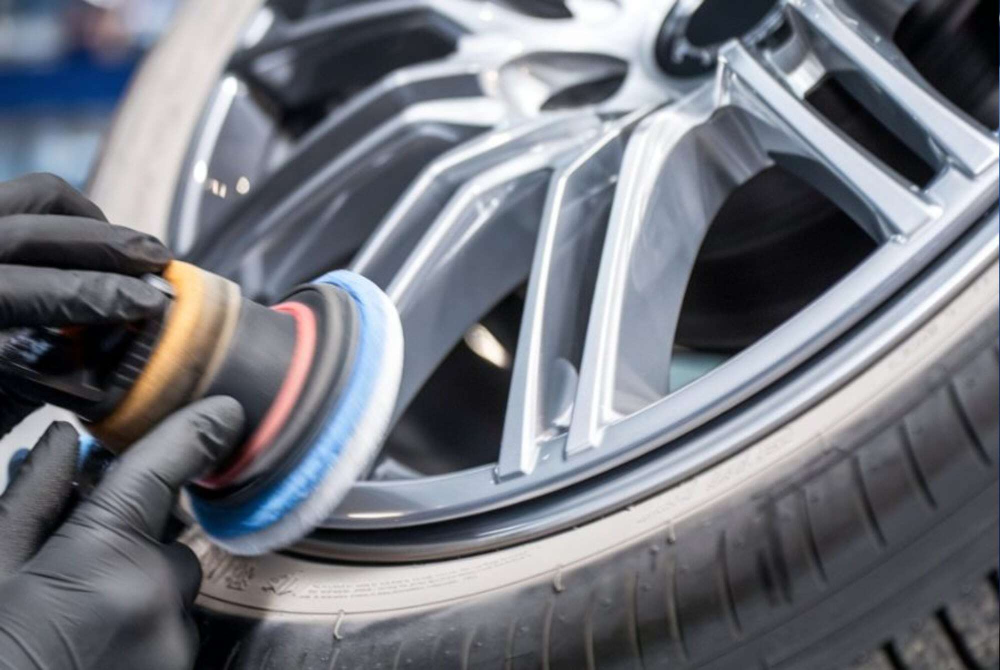 Tire Rotation Services tech polishing wheel Tire Rotation Services tech polishing wheel