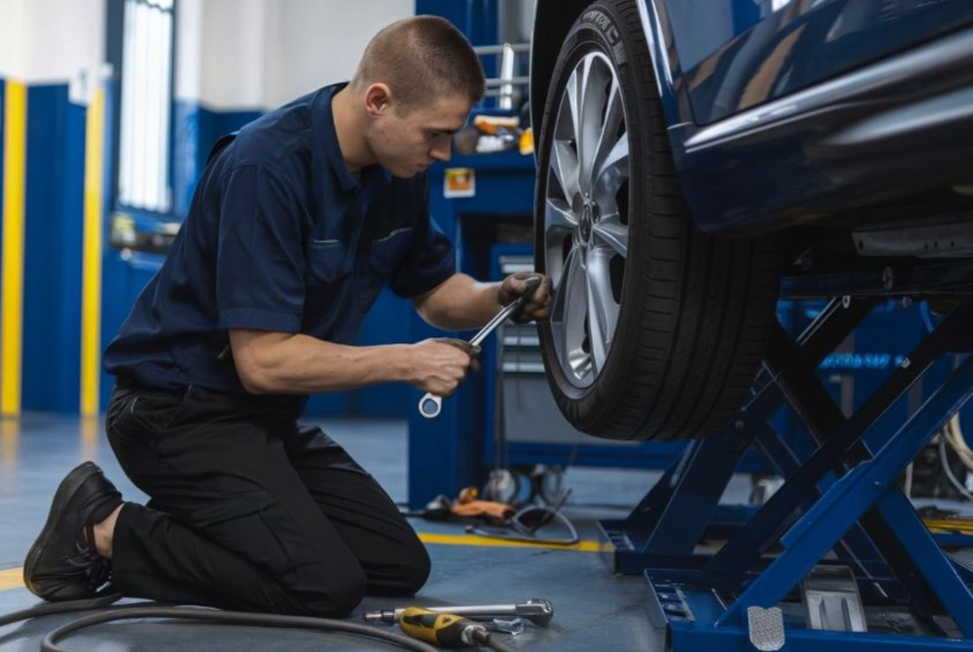 Tire Rotation Services tech installing wheel