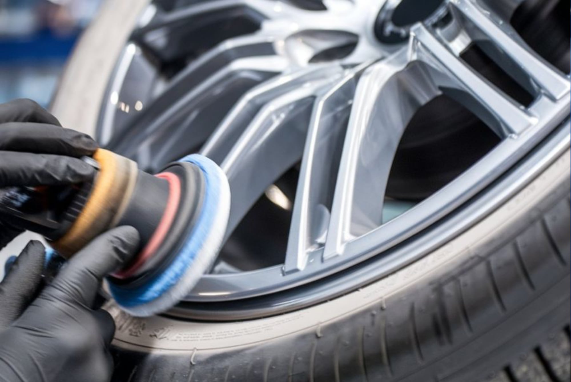 Tire Rotation Services tech polishing wheel